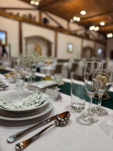 a table with plates and glasses on a white table cloth at Třebovický mlýn in Ostrava