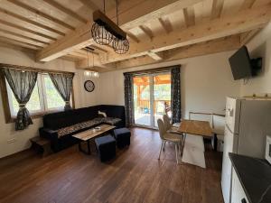 a living room with a couch and a table at Chata do Zlatneho in Terchová