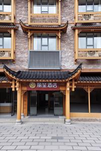 a building with an asian roof on the side of it at Lissen Hotel -5 min to Forest Park East Gate & Tour Tickets-Butler-recommended travel routes in Zhangjiajie