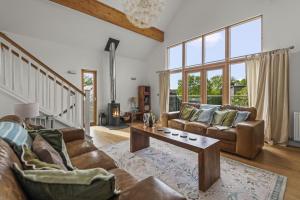 a living room with two couches and a coffee table at House 34 in Looe
