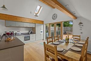 a kitchen and dining room with a table and chairs at House 34 in Looe