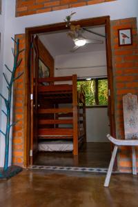 an open door into a room with a brick wall at Espaço Aricá in Chapada dos Guimarães