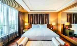 a bedroom with a large bed and a large window at G N Hotel & Restaurant Bodla in Agra +14 photos