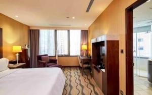 a hotel room with a bed and a desk at G N Hotel & Restaurant Bodla in Agra