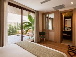 a bedroom with a bed and a sliding glass door at Arkk Rooms in Antalya +76 photos