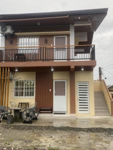 a small house with a balcony and a porch at Casa Gutierrez in Lingayen
