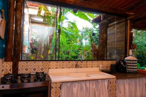 a kitchen with a sink and a window at Espaço Aricá in Chapada dos Guimarães +34 photos
