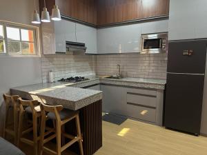 a kitchen with a black refrigerator and a counter at Casa Gutierrez in Lingayen