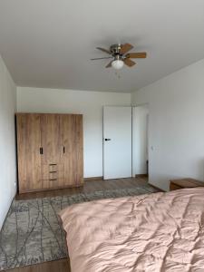 a bedroom with a bed and a ceiling fan at Панорама in Borysxaw +2 photos