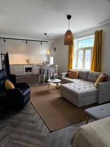 a living room with a couch and a table at Stava Mosters in Mariehamn