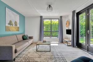 a living room with a couch and a table at 6 - Person Forest 183 Bungalow in Ewijk
