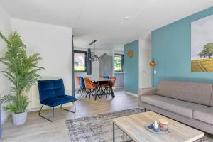 a living room with a couch and a table at 6 - Person Forest 183 Bungalow in Ewijk