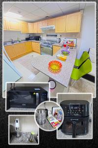 a kitchen with yellow cabinets and a counter top at Luxury Skyline Apartment with Panoramic Views in Sharjah