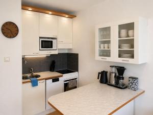 a kitchen with white cabinets and a counter top at Kotkan Studio in Kotka