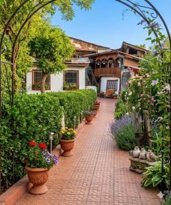 a brick walkway with pots of flowers and plants at Hotel New Green View a part in Srinagar