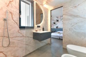 a bathroom with a sink and a shower at Moddissi Charme camere in Trappola +22 photos