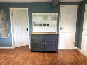 a black cabinet in a room with two doors at Heydon Private Guest Suite Self Check-in & Parking in Heydon