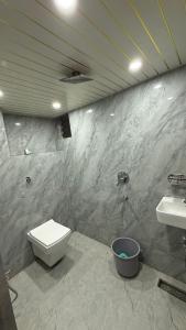 a bathroom with a toilet and a sink at Samarpan in Gorakhpur