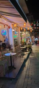 a restaurant with tables and chairs on a street at night at Patron Hotel in Antalya +58 photos