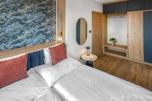 a bedroom with a bed with a large painting on the wall at Lazuli Apartment in Hegykő +55 photos