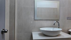 a bathroom with a bowl sink and a shower at Sanfhan Resort-SHA Plus in Khao Chai Son