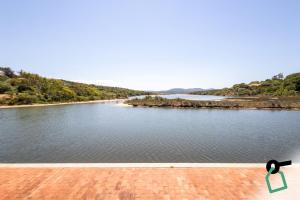 a view of a body of water with trees at Hotiday Punta Sardegna in Palau
