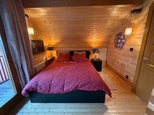a bedroom with a large bed in a wooden room at Résidences de Mélisa La Foux d'Allos in La Foux d'Allos