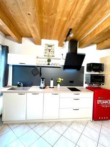 a kitchen with white cabinets and a red refrigerator at Ferienwohnung Südtor in Geisingen