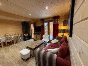 a living room with a couch and a table at Résidences de Mélisa La Foux d'Allos in La Foux d'Allos