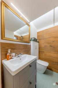 a bathroom with a sink and a mirror and a toilet at Oltre il Borgo in Valentano +8 photos