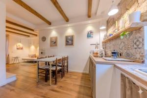 a kitchen and dining room with a table and chairs at Oltre il Borgo in Valentano