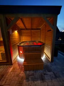 a sauna with a hot tub on a patio at Domek Góralski U Hanki Domek przy Stoku in Małe Ciche