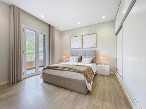 a bedroom with a large bed and a large window at Recanto do Sol by Atlantic Holiday in Caniçal