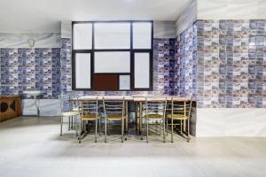 a dining room with a table and chairs and a window at Hotel O Jammu Near Ragunath Bazaar Formerly GoodWill in Jammu