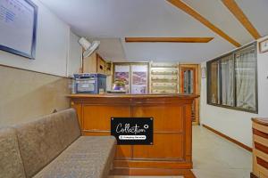 a room with a counter with a couch in it at Collection O Dandiya Bazar Formerly Vrundavan Residency in Vadodara