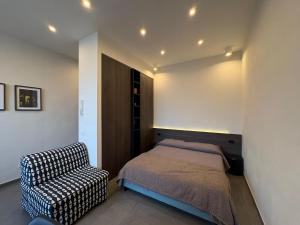 a bedroom with a bed and a chair at Stay in Naples in Naples