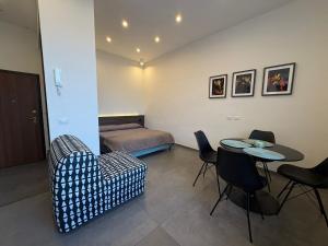 a room with a couch and a table and a bed at Stay in Naples in Naples