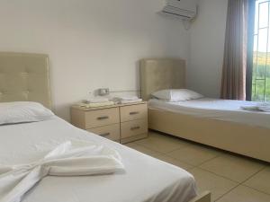 a bedroom with two beds and a window with a view at Kokaj3B in Hani Hotit