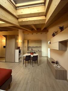 a kitchen and living room with a table and chairs at ValtellinaHome in Villa di Tirano