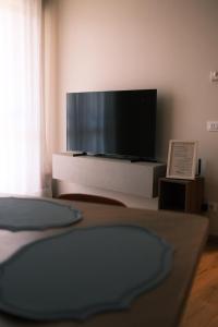 a living room with a large flat screen tv at Casa Delfina - Bergamo in Torre Boldone