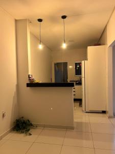 a kitchen with a counter and a refrigerator at Aconchego e conforto in Bom Jesus da Lapa