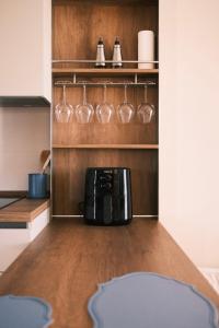 a kitchen with a coffee maker and wine glasses at Casa Delfina - Bergamo in Torre Boldone