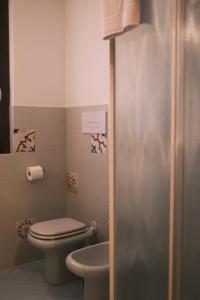 a bathroom with a toilet and a sink at Casa Delfina - Bergamo in Torre Boldone +17 photos