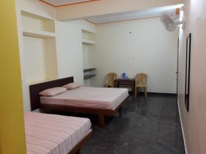 Postel nebo postele na pokoji v ubytování Pattiah Naidu Palace