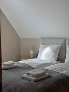 a bed with two towels sitting on top of it at Białe Wierchy Kościelisko in Witów