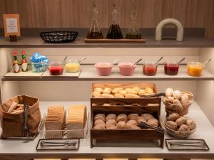 a shelf with different types of bread and other foods at Petit Palace Museum in Barcelona