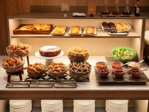 a buffet with different types of pastries and other foods at Petit Palace Museum in Barcelona
