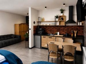 a kitchen and dining room with a table and chairs at Noclegi Na Końcu Świata Bielpon in Przemyśl