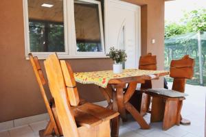 a table and chairs in a room with a window at Vikendica Trebižat river in Čapljina