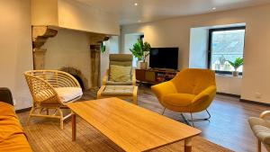 a living room with a couch and chairs and a table at Ty Neel - central - Wi-Fi in Crozon